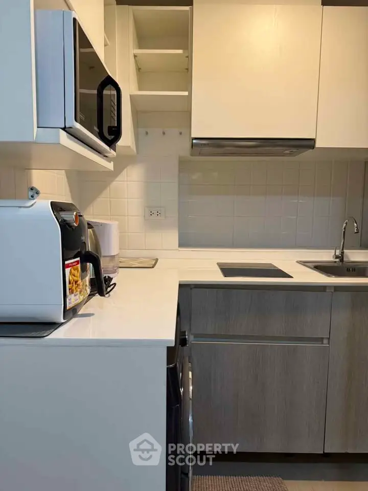 Modern kitchen with sleek cabinetry and built-in appliances, perfect for culinary enthusiasts.