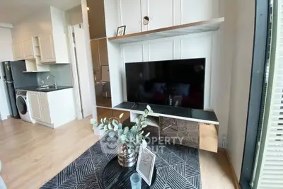 Modern living room with sleek TV unit and open kitchen layout