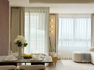 Elegant living room with modern decor and large windows for natural light