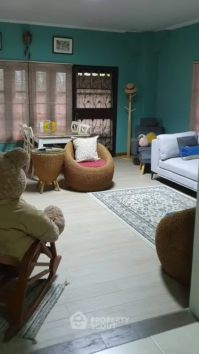 Charming living room with cozy seating and natural light, perfect for relaxation.