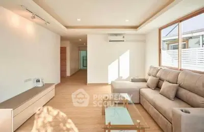 Spacious modern living room with natural light and stylish furniture