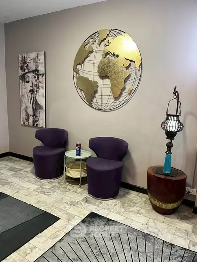 Stylish modern living room with unique wall art and chic seating area.