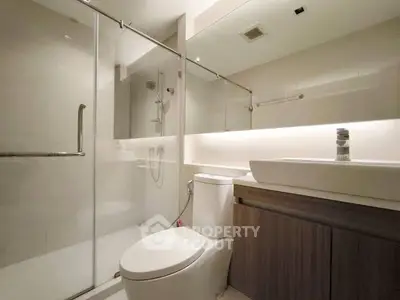 Modern bathroom with glass shower and sleek fixtures