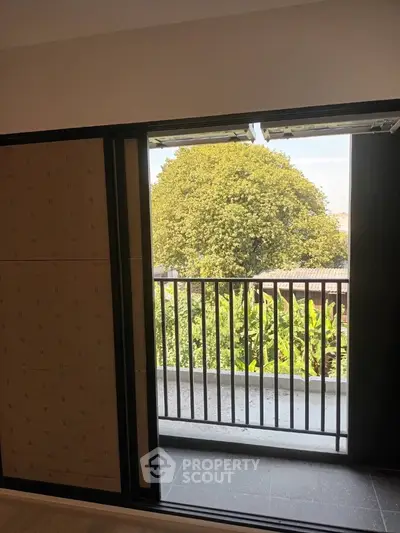 Charming balcony with lush green view, perfect for relaxation and enjoying nature.