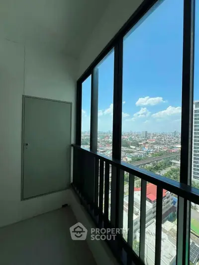 Stunning high-rise balcony with panoramic city views and abundant natural light.