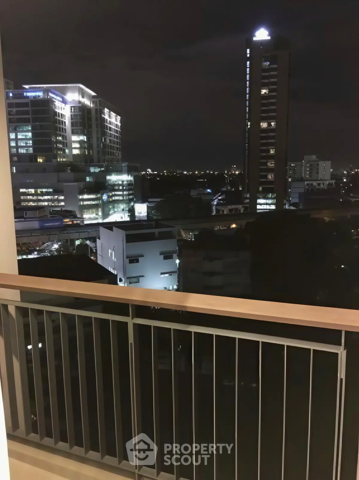 Stunning night cityscape view from a modern balcony, perfect for urban living enthusiasts.
