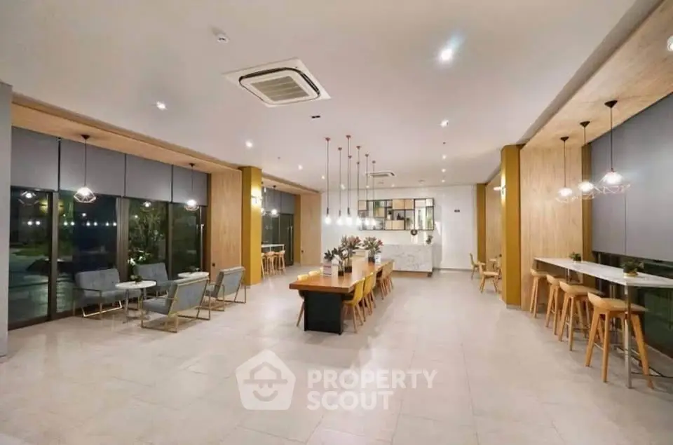 Spacious modern common area with elegant lighting and seating, perfect for gatherings.