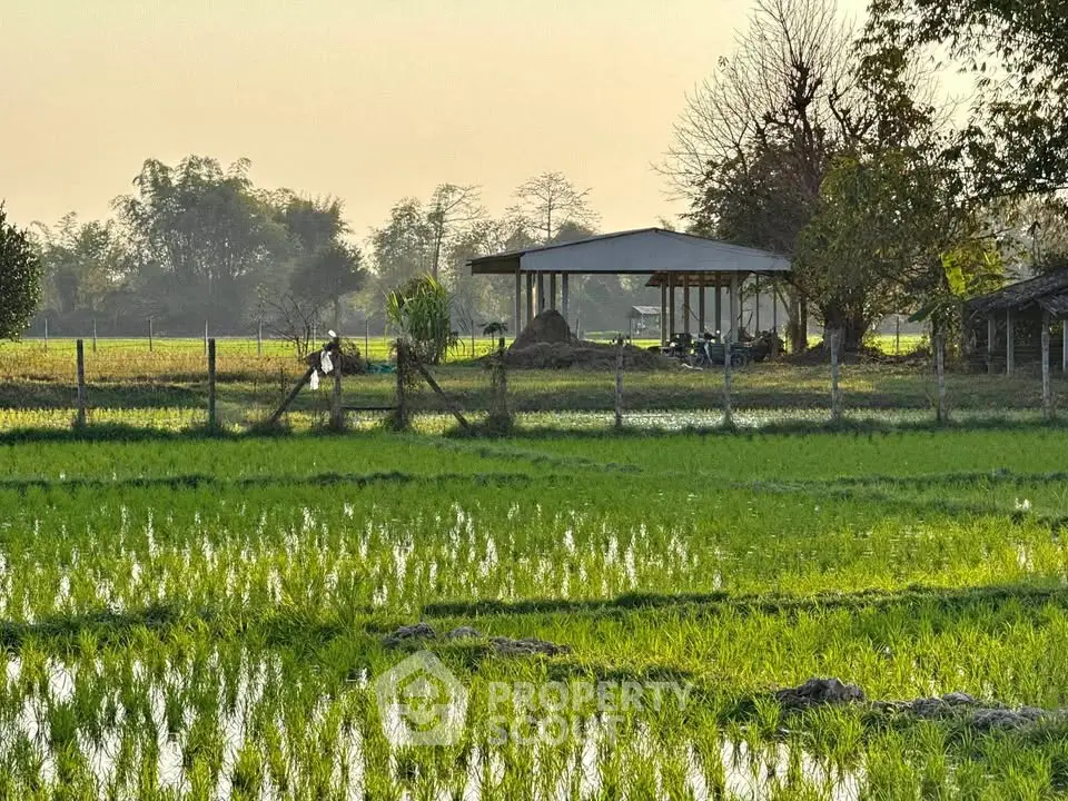 Scenic rural property with lush green fields and a rustic building