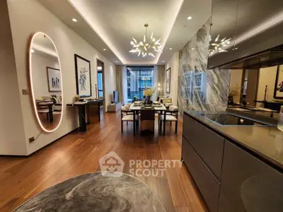 Luxurious modern living room with elegant decor and open layout, featuring stylish lighting and hardwood floors.