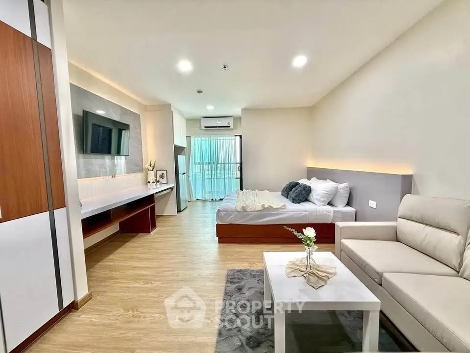 Modern studio apartment with cozy living area and stylish decor