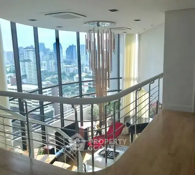 Luxurious duplex living room with panoramic city views and modern chandelier