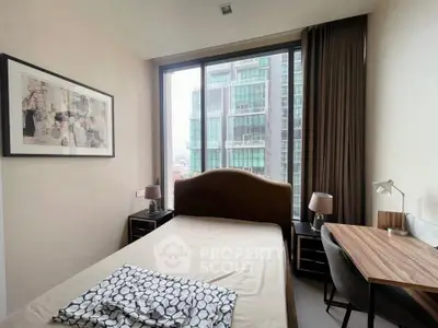 Modern bedroom with large window and city view, featuring stylish furniture and decor.