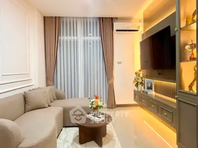 Elegant living room with modern decor, cozy sofa, and ambient lighting, perfect for relaxation and entertainment.