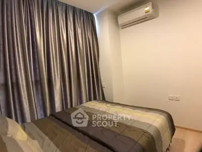 Cozy bedroom with modern air conditioning and elegant curtains