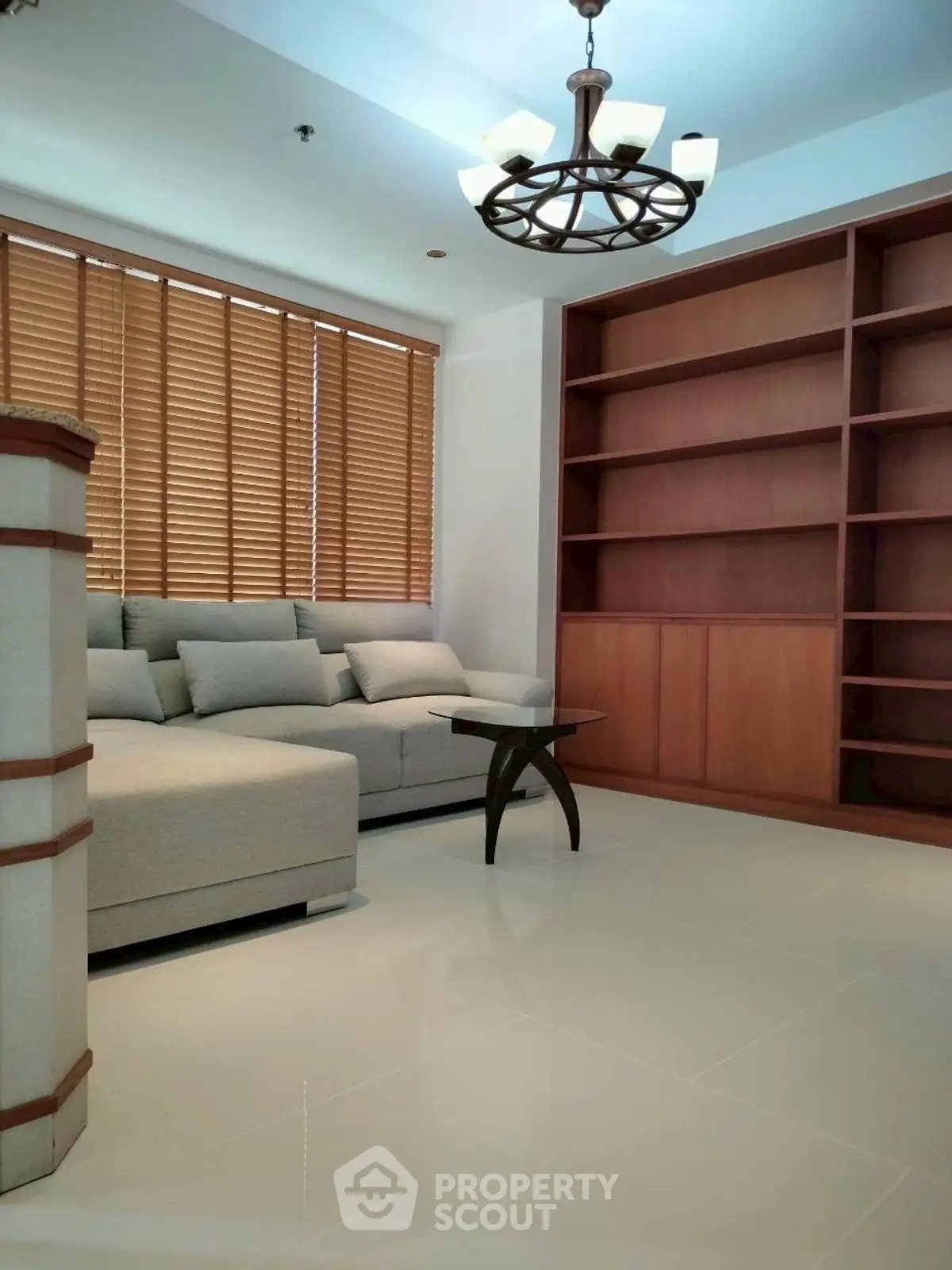 Spacious living room with modern sofa and elegant wooden shelves