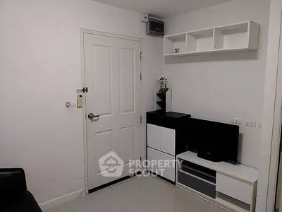 Modern minimalist living room with sleek white furniture and wall-mounted shelves.