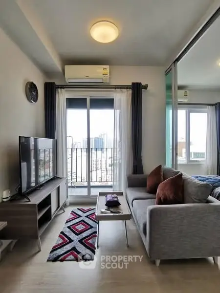 Modern living room with city view, stylish decor, and cozy ambiance.