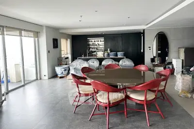 Spacious modern living room with elegant dining area and balcony access