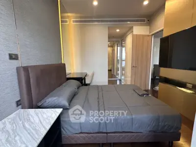 Modern bedroom with sleek design and luxurious furnishings in a high-end apartment.