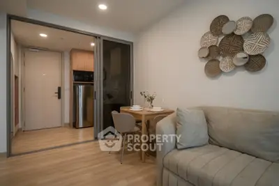 Modern living room with cozy sofa and dining area in open layout apartment.