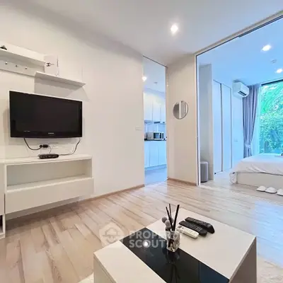 Modern living room with open layout and sleek kitchen view