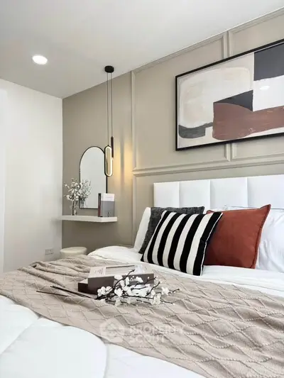 Stylish bedroom with modern decor and cozy bedding, featuring elegant wall art and ambient lighting.