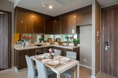 Modern kitchen with sleek cabinetry and dining area in stylish apartment