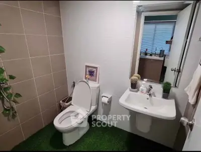 Modern bathroom with unique artificial grass flooring and stylish decor