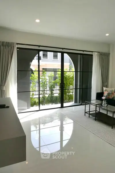 Modern living room with large glass doors and garden view