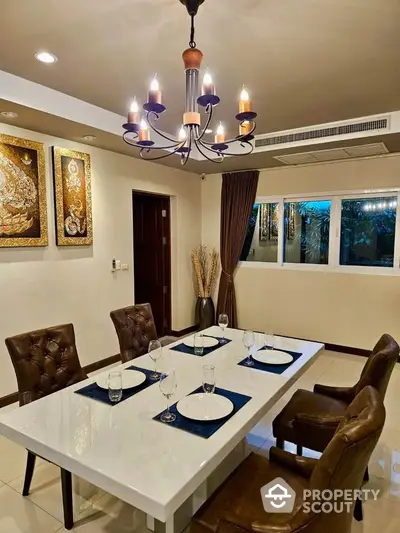 Elegant dining room with modern chandelier and stylish decor, perfect for entertaining guests.