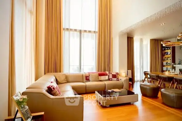 Luxurious living room with high ceilings and elegant decor in modern apartment.