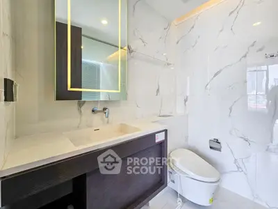 Luxurious modern bathroom with sleek marble finishes and elegant fixtures.