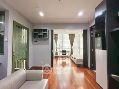 Spacious modern living room with wooden flooring and natural light