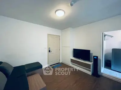 Modern living room with sleek furniture and TV setup, perfect for cozy evenings.