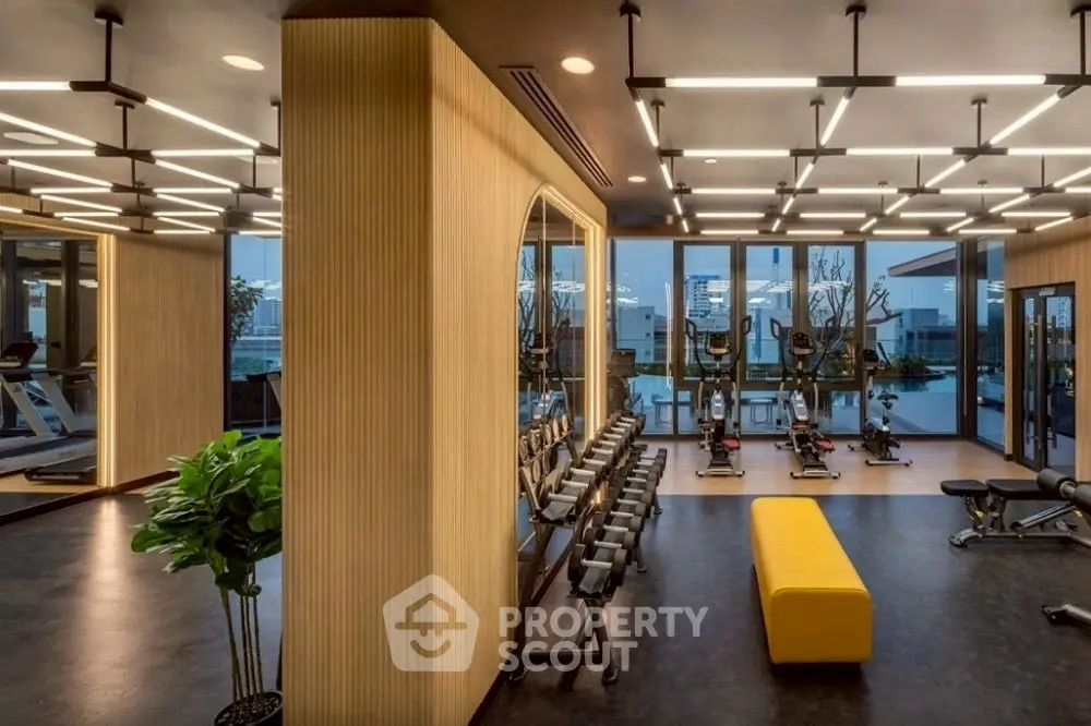 Luxurious modern gym with state-of-the-art equipment and panoramic city views.