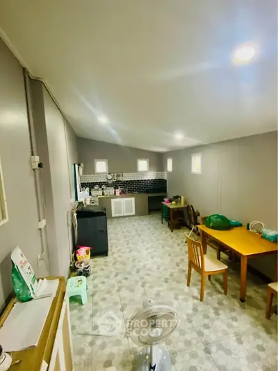 Spacious kitchen with modern appliances and dining area, perfect for family gatherings.