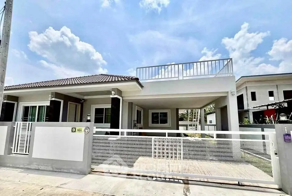 Modern single-story house with rooftop terrace and gated driveway