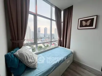 Cozy bedroom with city view, large windows, and stylish decor in modern apartment.