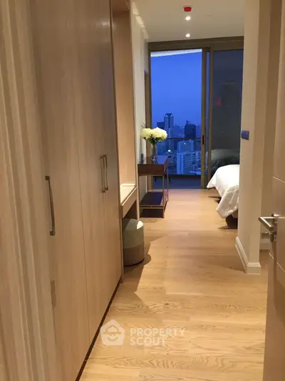 Luxurious bedroom with stunning city view and elegant wooden flooring