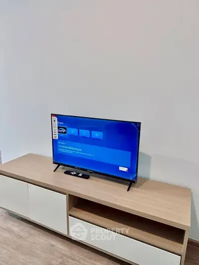 Modern living room with sleek TV stand and flat-screen television.