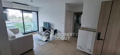 Modern living room with large window and stylish furniture in a contemporary apartment.