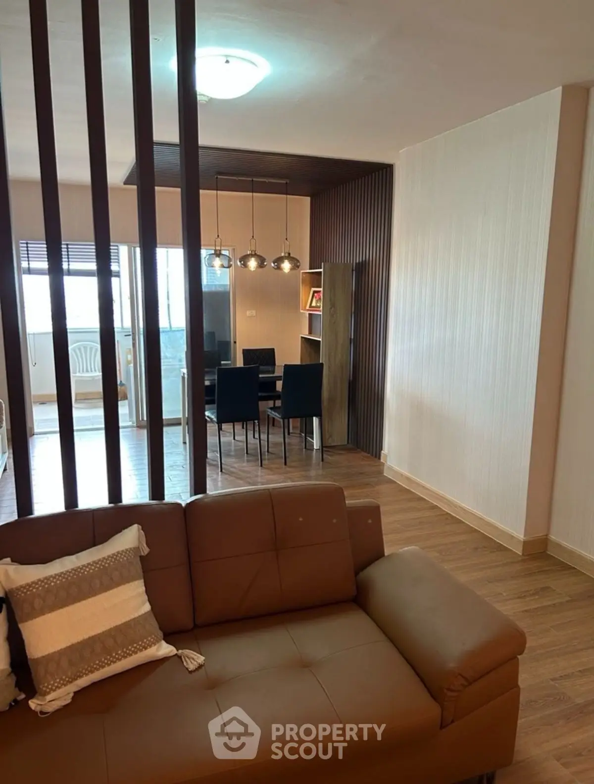 Modern living room with stylish dining area and wooden flooring