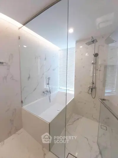 Luxurious marble bathroom with modern fixtures and elegant bathtub