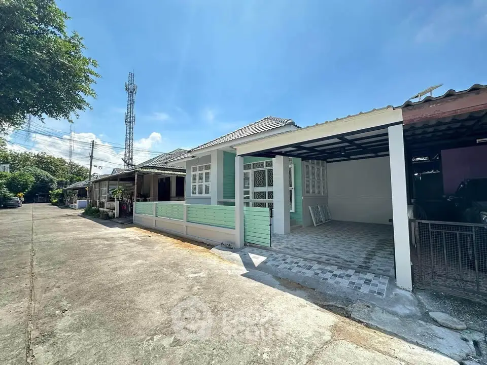 Charming single-story home with spacious driveway and modern exterior design.