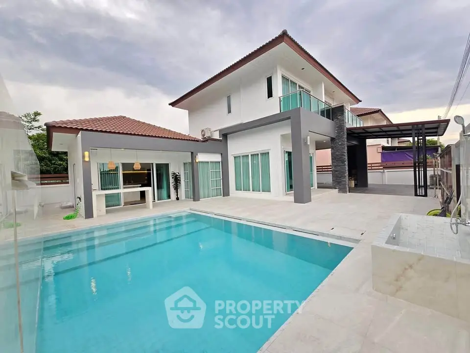 Luxurious modern house with pool and spacious patio, perfect for relaxation.