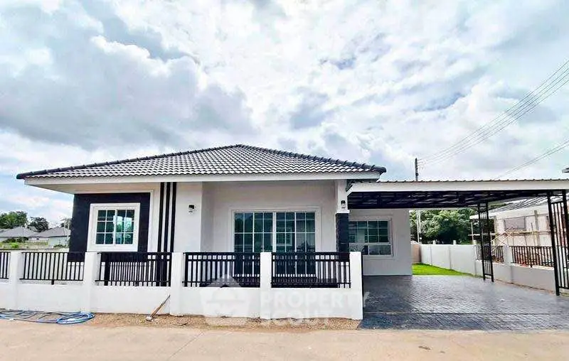 Charming single-story house with modern design and spacious driveway.