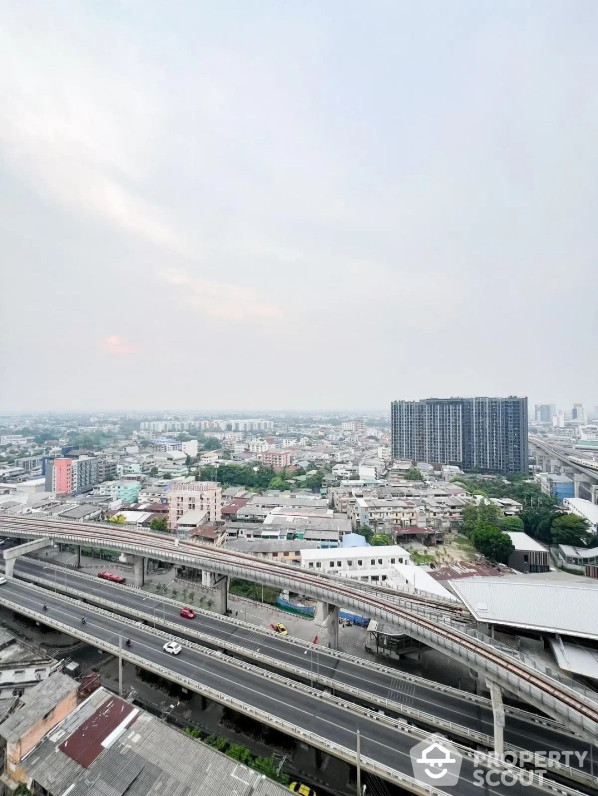 Stunning urban view from high-rise building overlooking cityscape and highways.