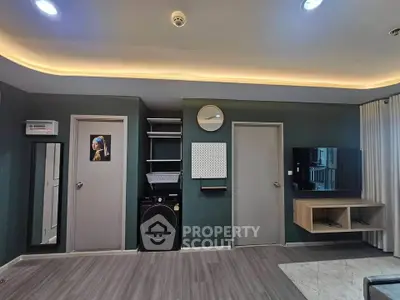 Modern living room with sleek design, featuring a washing machine and stylish wall decor.