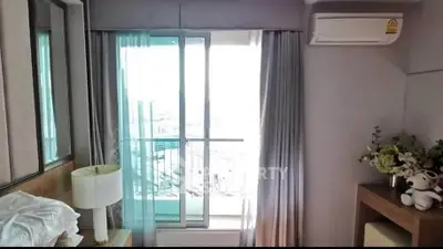 Cozy bedroom with balcony access and air conditioning in modern apartment
