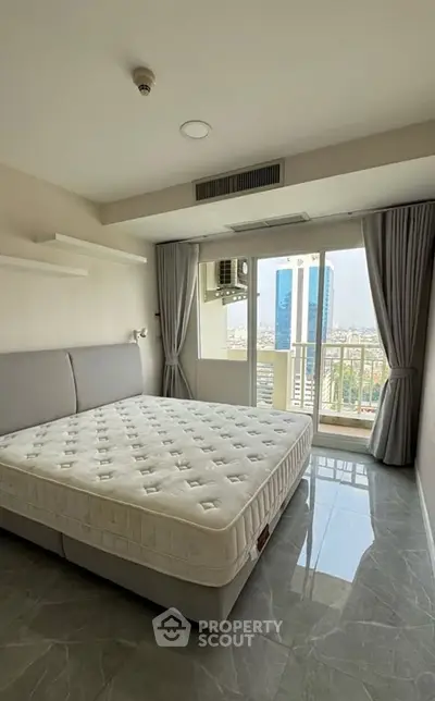 Spacious bedroom with city view and modern design in high-rise apartment